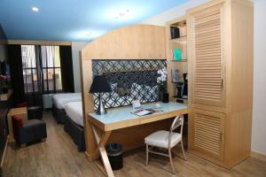 a bedroom with a bed and a desk in a room at TRYP by Wyndham New York City Times Square - Midtown in New York