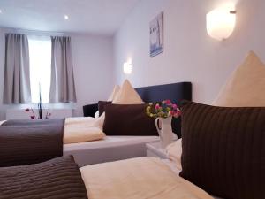 a living room with two beds and a couch at Füssen Apartments - Center Apartments in Füssen