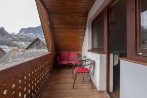 a balcony with two chairs and a table at Old Mill House in Bohinj