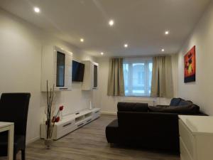 a living room with a couch and a window at Füssen Apartments - Center Apartments in Füssen