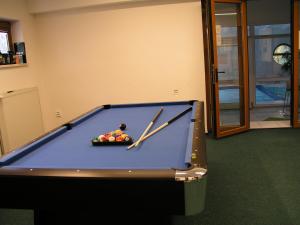 a pool table with two cue sticks and balls on it at Villa Vlasta in Karlovy Vary +62 photos