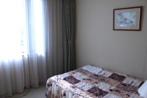 Postel nebo postele na pokoji v ubytování Grand Hotel Hakusan
