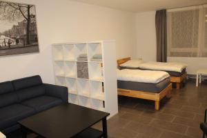 uma sala de estar com duas camas e um sofá em Libarty Appartments em Kornwestheim