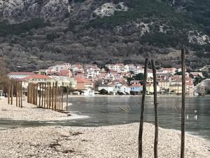 a view of a town on the water with houses at Apartments More in Baška