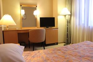 Postel nebo postele na pokoji v ubytování Grand Hotel Hakusan