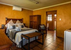 a bedroom with a bed and a table in it at Kuruman Hotel in Kuruman