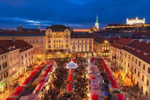 a large crowd of people in a city at night at VIP Apartment in Old Town with free parking in Bratislava