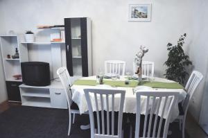 a dining room with a table with chairs and a tv at Apartment Center in Split