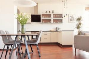 a kitchen and dining room with a table and chairs at Luxury Panoramic Vilnius apartment in Vilnius