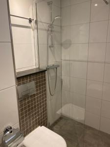 a bathroom with a toilet and a glass shower at Hotel De Weyman in Santpoort-Noord