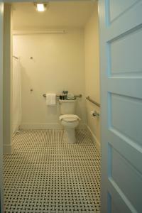 a bathroom with a toilet and a tiled floor at Higgins Beach Inn in Scarborough