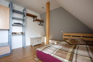 a attic bedroom with a bed and a ladder at Bielefeld Zentral in Bielefeld