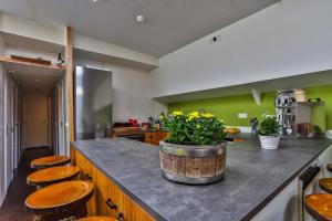 a kitchen with wooden stools and a counter with a barrel at Hotelschip Bracksand Amsterdam City, in de zomer én de winter! in Amsterdam