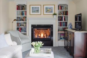 a living room with a fireplace and a couch at The Bellmoor Inn and Spa in Rehoboth Beach