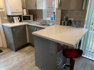 una pequeña cocina con encimera y fregadero en WV1 Bridge House - 3 Bedrooms, sleeps 6 free Parking - New Cross - Bentley Bridge - 欢迎 en Wolverhampton