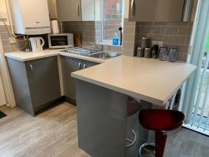 a small kitchen with a counter and a sink at WV1 Bridge House - 3 Bedrooms, sleeps 6 free Parking - New Cross - Bentley Bridge - 欢迎 in Wolverhampton