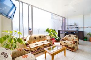 a living room with two couches and a tv at Ayenda 1069 Alfay in Bogotá