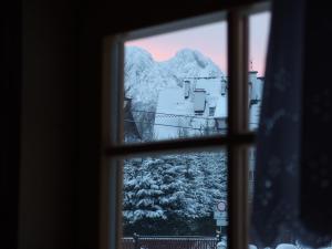 a view of a mountain through a window at Misia Chata in Zakopane