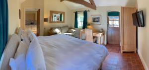 a bedroom with a large bed and a living room at Hollies Farm B&B in Wrexham