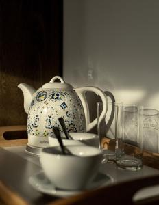um bule de chá e duas taças numa mesa em Apartamenty Folk & Art Krupówki 25 em Zakopane