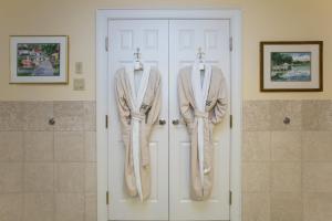 two robes hanging on the doors of a bathroom at The Bellmoor Inn and Spa in Rehoboth Beach