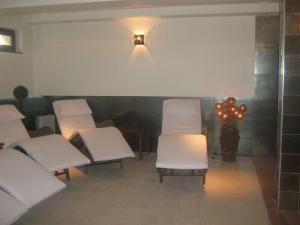 a waiting room with white chairs and a bunch of lights at Hotel Villa Ofir in Sandanski