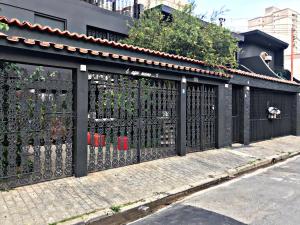 une clôture noire sur le côté d'une rue dans l'établissement Pousada Casa dos Gattos - Próx ao Aeroporto Guarulhos, à Guarulhos