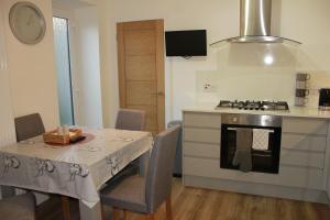 a kitchen with a table and a stove at Ground Floor Apartment in Montrose