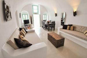 a living room with a couch and a table at Cavern House Anthea in Éxo Goniá