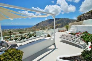 a balcony with stairs and a view of the ocean at Cavern House Anthea in Éxo Goniá