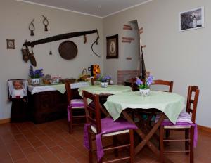 ein Esszimmer mit zwei Tischen und Stühlen, die mit Blumen geschmückt waren in der Unterkunft Borgo Lamurese in Avigliano