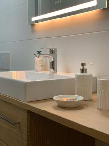 a bathroom with a sink and a bowl on a counter at Lucashof Millstättersee in Millstatt