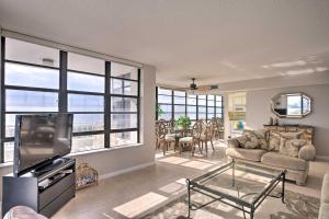a living room with a couch and a tv at Beachfront Marco Island Resort Condo with Pool! in Marco Island