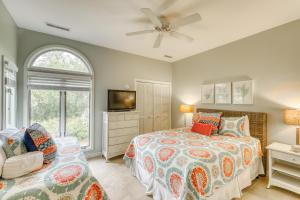 a bedroom with a bed and a flat screen tv at 4522 Parkside Villa in Kiawah Island