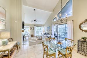 a dining room and living room with a glass table and chairs at 4522 Parkside Villa in Kiawah Island