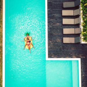 a woman in a bikini swimming in a pool at The Moso in Port Vila