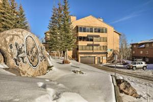 a large rock with a painting on it in front of a building at Ski-Out Brian Head Condo - Top of Navajo Lift in Brian Head
