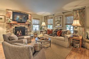 a living room with a couch and a fireplace at Lush Mirror Lake Cottage Rental with Private Deck in Highlands