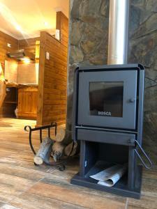a fireplace with a tv in a room at Refugio del Maipo Lodge in San José de Maipo