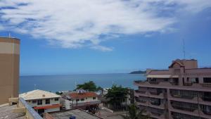 a view of a city with the ocean in the background at Apartamento na praia de Bombas Edifício Umuarama nº 63, bloco B in Bombinhas