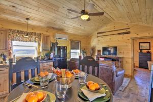 a kitchen and dining room with a table with oranges on it at Valley View Cabin Near Branson and Table Rock Lake in Omaha
