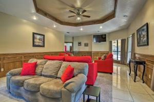 a living room with a couch and red pillows at Waterfront Harlingen Home with Pool, Patio and Gazebo! in Harlingen