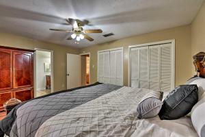 a bedroom with a bed with a ceiling fan at Pet-Friendly Missouri City Home with Fenced-In Yard! in Missouri City