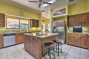 a large kitchen with wooden cabinets and stainless steel appliances at Waterfront Harlingen Home with Pool, Patio and Gazebo! in Harlingen