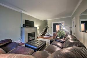 a living room with a leather couch and a fireplace at Spacious Reading Home with Patio - 2 Miles to Pagoda! in Reading