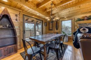 a dining room with a wooden table and chairs at Crazy Horse in Pigeon Forge