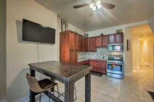 a kitchen with a wooden table and a flat screen tv at Philadelphia Apartment Walk to Bus and Train Stops! in Philadelphia