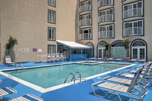 a pool in front of a hotel with chairs and a building at Newly Updated Condo with Beautiful Views and Location! in Ocean City