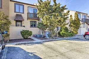 a house with a car parked in a driveway at Family-Friendly Wildwood Townhome about 3 Mi to Beach in Wildwood