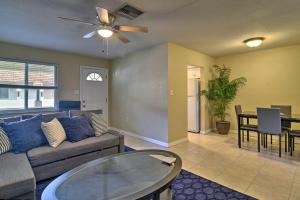 a living room with a couch and a table at Cozy Indian Rocks Beach Condo - Steps to Beach! in Clearwater Beach